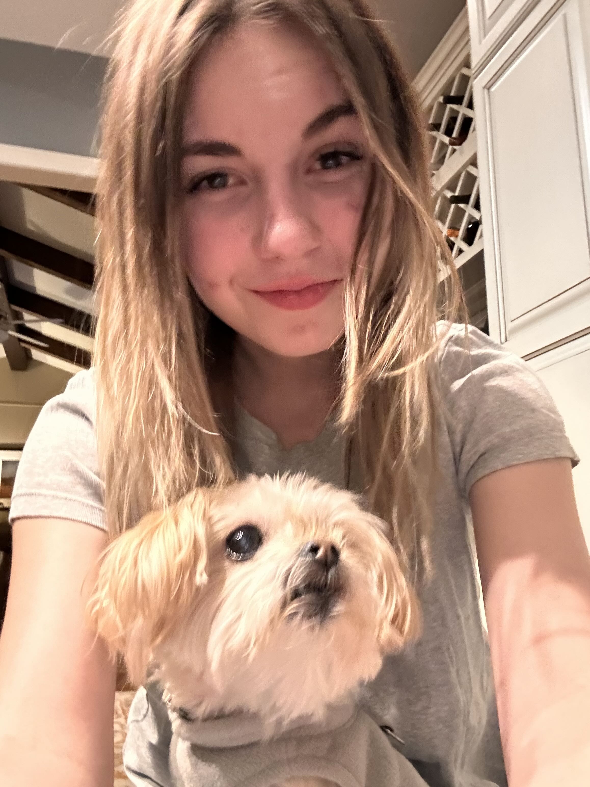 Samantha holding a Yorkshire Terrier indoors